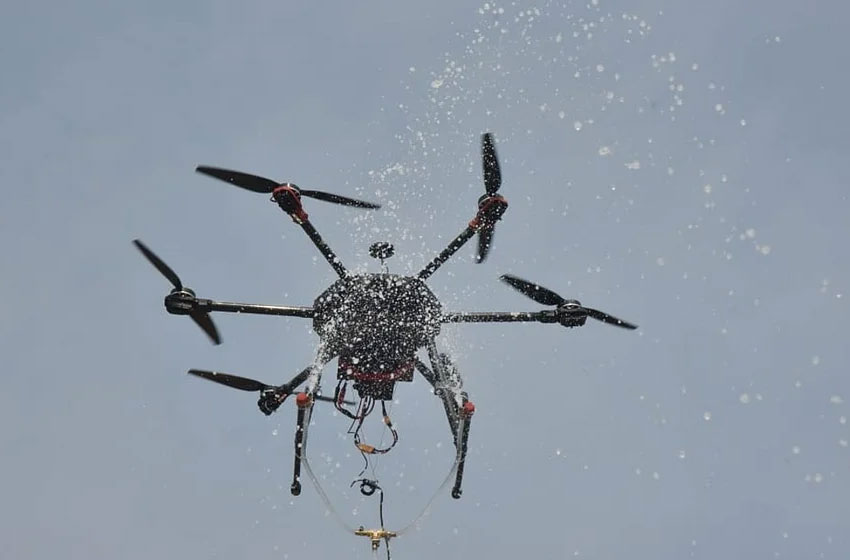 Drones spray water from the Ganges on devotees during Ganga Sagar Festival